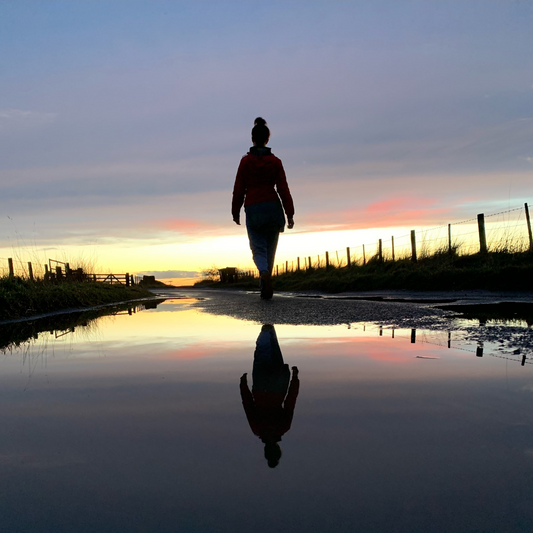 Walking with purpose - reflections in water - intentionality - sunset